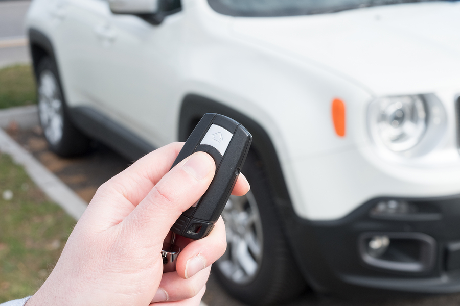 Hand holding a car alarm key with anti-theft